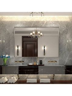 an elegant bathroom with marble counter tops and dark wood cabinets, along with chandelier