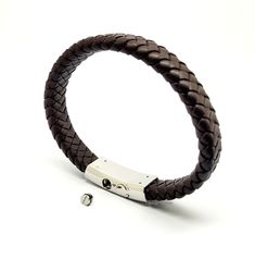 This stylish keepsake bracelet is made from highly polished premium-grade 316L non-tarnish stainless steel, with intricately braided brown leather straps.  As with all of our cremation/keepsake includes a discreet chamber in which to hold a small, token amount of ashes, fur, sacred earth or whatever you wish to hold close. All orders come complete with a presentation/gift box and a filling kit. The bracelet comes in 4 lengths:  Extra Small - 18cm/7.25inch long, to fit wrists up to 16cm (6 inches Urn Bracelet, Brown Leather Strap, Memorial Jewelry, Brown Leather, Leather Straps, Braids, Bracelet, Bangles, Etsy Shop