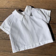 vintage kids 60s 70s white pleated short sleeve top Vintage 60s 70s white pleated shirt sleeve button back Great preowned condition No tags / labeled Probably for around 12 mos 10” long 10.5” pit to pit 10.5” across waist 3.5” sleeve Cotton or cotton poly blend Price includes flat rate expedited usps shipping Spring Pleated Short Sleeve Blouse, Casual Pintuck Short Sleeve Tops, Casual Short Sleeve Tops With Pintucks, Short Sleeve Pleated Blouse For Spring, Pleated Short Sleeve Blouse For Spring, Fitted Pleated Summer Tops, Casual Pleated Short Sleeve Blouse, Casual Short Sleeve Pleated Blouse, Fitted Cotton Pleated Top