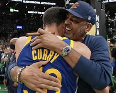 two men hugging each other at a basketball game