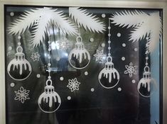 a window decorated with christmas ornaments and snowflakes