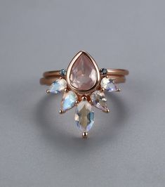 an image of a ring with stones on the front and back, set in gold