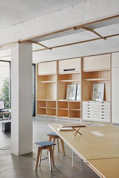 an office with wooden shelves and white desks