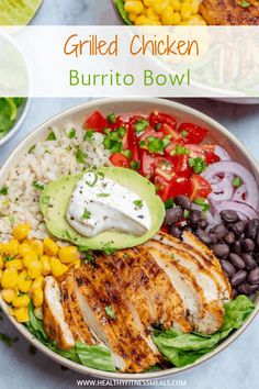 grilled chicken burrito bowl with black beans, corn and avocado on the side