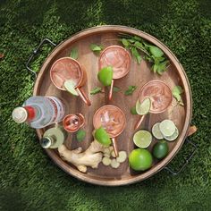 an overhead view of various alcoholic drinks on a wooden tray