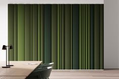 a room with a table, lamp and green striped wall paper on the wall behind it