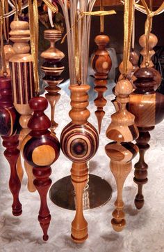 a bunch of wooden objects hanging from a ceiling