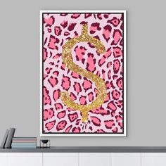 a pink and gold leopard print with a dollar sign on the front, against a gray wall