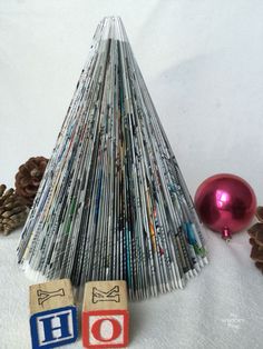 a christmas tree made out of magazines and wooden blocks with the word ho written on them