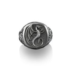 Winged Dragon, Sterling Silver Square Signet Ring, Mythical Creature, Mens Rings, Pinky Rings for Women, For Mythology Enthusiasts This stylish ring is ideal for everyday use. The engraving details of the 925k handmade silver ring is very eye-catching. Not a shiny piece, we oxidize our designs, but can be rhodium plated on request. ★Item Details *  Gender : Male / Female *  Material : 925K Sterling Silver *  Total weight : 12.00 - 14.00 Grams  (For 11 Ring Size) *  Ring Diameter : 0.72 inches  -  (1.84 Cm) * All our products are handmade and weights may vary  (-) 1,00 gram * We recommend using the oxidized version of it. Also, the photos are of the oxidized version of the ring * If you want to have Solid Gold, please don't hesitate to contact us about our perfect price offers * Ring Size: Dragon Signet Ring, Pinky Rings For Women, Winged Dragon, Pinky Rings, Handmade Silver Ring, Mens Rings, Mythical Creature, Dragon Wings, Stylish Rings