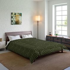 a bedroom with a bed, nightstands and two lamps on either side of the bed