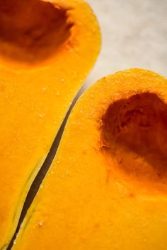 the inside of a yellow squash is cut in half and ready to be sliced into smaller pieces