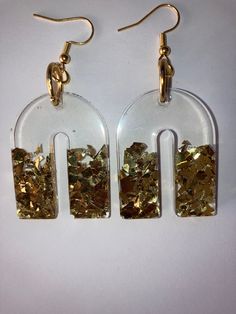 Clear resin with gold sparkles. Trendy Gold Festive Jewelry, Trendy Gold Jewelry For Festive Occasions, Sparkling Gold Jewelry For Festive Occasions, Festive Sparkling Gold Jewelry, Trendy Sparkling Gold Jewelry, Elegant Glitter Gold Jewelry, Elegant Glittering Gold Jewelry, Chic Gold Resin Jewelry, Gold Glitter Jewelry As Gift