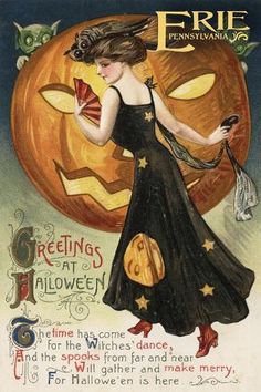 a woman in a black dress is holding a fan and standing next to a pumpkin