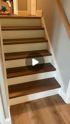 the stairs are made of wood and have been painted white with brown stripes on them