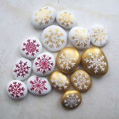 several different types of buttons with snowflakes on them, all in gold and white