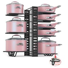 pink pots and pans are stacked up on black racks with metal brackets to hold them