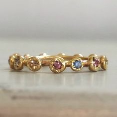 Eternity Gold Ring, Gold Sapphire Ring, Engagement Ring, Eternity Band, Gold Stacking band, Sapphire Engagement Ring, Anniversary Ring. Original and unique gold band with multi color sapphires set all around. Delicate and very classic, fine piece of jewelry. Solid 14 karat Gold, hand crafted. You can wear it as a single band, or stack it up for extra vibrant colors. Details - * 14 karat solid yellow gold. * Multi color Sapphires, set all around (14 stones all together). * Width - 3.5 mm / 0.4 in Multicolor Stackable Round Band Rings For Anniversary, Multicolor Stackable Rings For Anniversary, Gold Stackable Sapphire Ring, Yellow Gold Eternity Band With Birthstone, Gold Eternity Band With Birthstone, Multicolor Stackable Birthstone Ring, Gold Multi-stone Sapphire Promise Ring, Multicolor Stackable Eternity Band As Gift, Gold Sapphire Ring With Halo