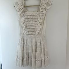 Great As A Bathing Suit Coverup Or As A Fun Dress! Eyelet And Ruffles And A Great Light Material. Worn And Loved! A Small Stain On The Front (Pictured) And Slight Discoloration At The Top Of The Neckline (Pictured). I’m A Size 4 And It Fits Perfectly! Off White Sleeveless Ruffled Mini Dress, Off White Sleeveless Mini Dress With Ruffles, Off White Ruffled Dress For Day Out, Bohemian Off-white Mini Dress With Ruffles, Off White Bohemian Mini Dress With Ruffles, Bathing Suit Coverup, Fun Dress, Bathing Suit Cover Up, Bathing Suit