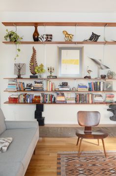 a living room filled with furniture and bookshelves on top of it's shelves