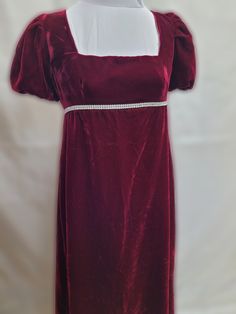 This dress has free standard shipping included!  Standard shipping Air Mail, no tracking.  If you would like Express Post or place by place tracking, please contact us, and we can set that up for you!   We offer a basic Regency styled gown, with the empire waist and short puffed sleeves.  This dress is made with a deep red velvet, with a rhinestone trim around the front waist.    *This gown ties at the back with ribbons which can adjust the fit.      * All seams have been finished and this gown Fitted Burgundy Dress For Christmas, Elegant Fitted Holiday Dress For Costume Party, Elegant Fitted Dress For Costume Party, Regency Style Red Dress For Costume Party, Red Regency Costume Dresses, Regency Style Red Costume Dress, Elegant Holiday Costume Dress, Costume Dress With Fitted Bodice And Empire Waist, Empire Waist Costume Dress With Fitted Bodice