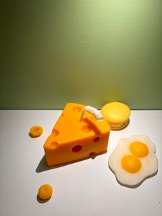 a piece of cheese and two eggs on a table