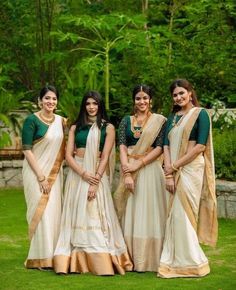 the bridesmaids are posing for a photo in their traditional sari attires