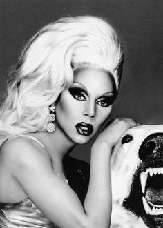 lady with black and white makeup posing next to a polar bear