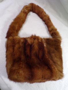 Beautiful brown mink handbag. 12" x 9", 10" strap drop.  The zipper and a plaque inside the bag has the initials CEN. Brown Shoulder Bag With Faux Fur Lining For Winter, Elegant Brown Bag For Winter, Elegant Brown Winter Bags, Evening Rectangular Bag With Faux Fur Lining, Brown Faux Fur Lined Shoulder Bag For Winter, Brown Winter Shoulder Bag With Faux Fur Lining, Brown Bag With Faux Fur Lining For Shopping, Brown Shopping Bag With Faux Fur Lining, Rectangular Faux Fur Evening Bag