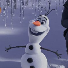 a snowman is standing in the snow with icicles hanging from it's ears