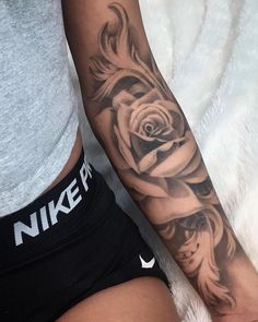 a woman's arm with a rose tattoo on the left side of her body