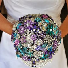 a colorful brooch sitting on top of a white surface