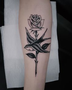 a black and white rose tattoo on the leg