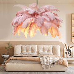 a large pink feather chandelier hanging over a bed