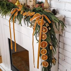 a decorated mantle with orange slices and pine cones