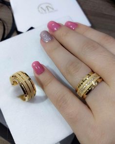 two gold rings sitting on top of each other