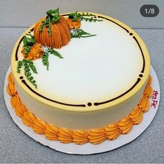 a cake decorated with orange flowers and leaves