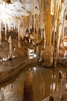 the inside of a cave filled with water and icicles