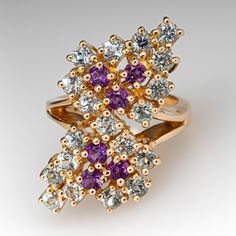 This gorgeous topaz and amethyst cocktail ring is accented with six (6), prong set, round modified brilliant cut natural amethyst and nineteen (19), prong set, round modified brilliant cut natural topaz. The ring measures 33.3mm at the top, rises 10.5mm above the finger, tapering to 3.3mm wide and 1.4mm thick at the base of the shank. It is currently a size 7.75. Purple Multi-stone Cluster Ring For Anniversary, Elegant Purple Multi-stone Cluster Ring, Fine Jewelry Amethyst Cluster Ring For Anniversary, Cluster Amethyst Ring For Anniversary, Purple Multi-stone Diamond Ring For Anniversary, Amethyst Cocktail Ring, Cocktail Rings, Blue Topaz, Prong Setting