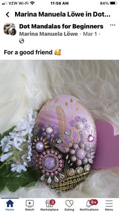 an easter egg decorated with flowers and pearls