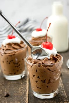 two dessert cups with chocolate pudding and cherries