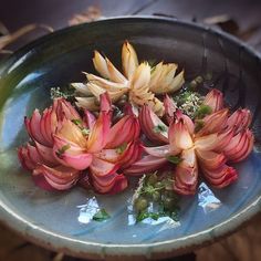 there are many flowers in the bowl that is on the stove burner and ready to be cooked