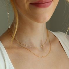 Showcase your elegance with our Floating Pearl Backdrop Necklace. This necklace features two delicate layered chains in the front and three gorgeous freshwater pearls cascading down the back– a stunning show stopper that will compliment your backless wedding dress. DETAILS14k gold fill or sterling silverChoose from the shortest chain measuring 16" or 18" with the second chain dropping an additional 2" Backdrop chain with pearls measures 9"Hypoallergenic and waterproof Elegant Double Strand Backdrop Necklace With Delicate Chain, Minimalist Double Strand Pearl Chain Necklace, Delicate Pearl Chain Necklace For Layering, Elegant Pearl Layered Necklace With Delicate Chain, Elegant Wedding Necklace With Satellite Chain, Delicate Pearl Necklace For Layering, Elegant Pearl Necklace With Adjustable Chain For Layering, Classic Pearl Chain Necklace For Wedding, Gold Layered Pearl Chain Necklace For Wedding