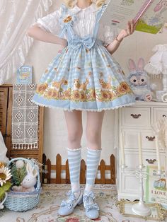 Step into a world of whimsical charm with our Sunflowers and Kitty Print Lolita Blue Plaid Skirt with Detachable Straps. This enchanting skirt features a delightful blend of sunflowers and adorable kitty prints, set against a classic blue plaid backdrop. The detachable straps add a versatile touch, allowing you to customize your look effortlessly. Made from high-quality, breathable fabric, this skirt ensures both comfort and style. Perfect for Lolita enthusiasts and kawaii fashion lovers alike, Cute Fitted Blue Skirt, Kawaii Fitted Bottoms For Spring, Cute Fitted Light Blue Skirt, Spring Kawaii Tiered Skirt, Cute Blue Tiered Skirt Bottoms, Cute Blue Tiered Skirt, Cute Blue Skirt For Spring, Playful Blue Skirt For Spring, Playful Fitted Blue Skirt