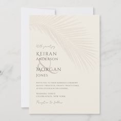 an elegant wedding card with palm leaves on the front and bottom, in neutral tones