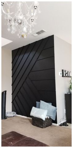 a living room with a black wall and chandelier