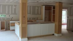 an empty kitchen and living room in a house under construction with unfinished walls, cabinets, and flooring