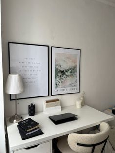 a white desk with two pictures above it