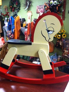 a wooden rocking horse sitting on top of a table