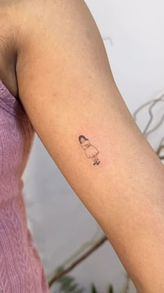 a woman with a small tattoo on her arm